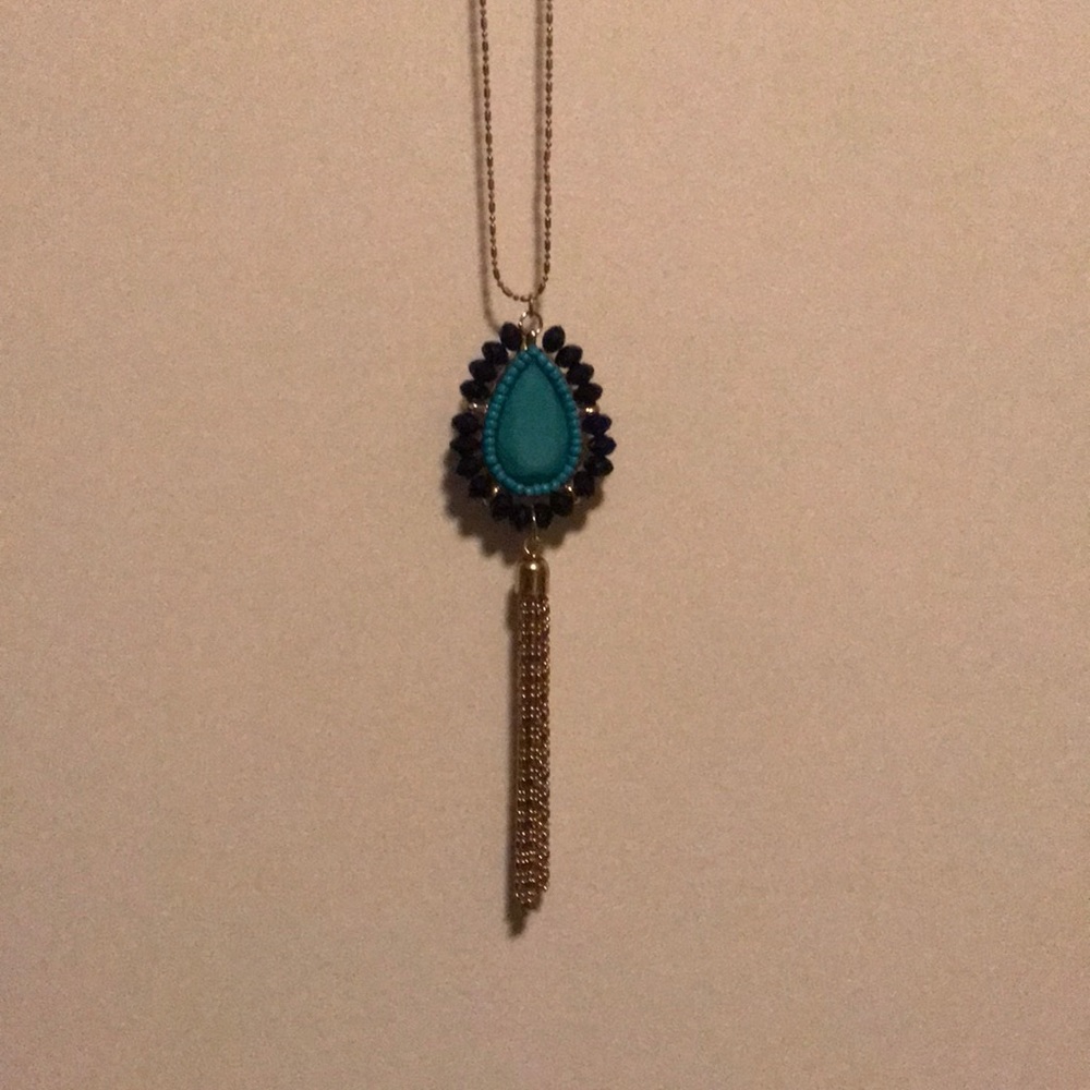 Gold toned costume long tassel necklace.